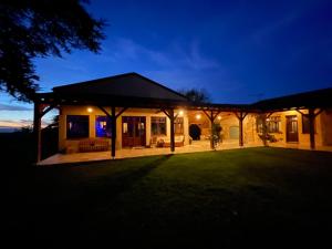 a house with a patio at night at LAURAGUEL CHAMBRES D'HÔTES in Mourvilles-Hautes