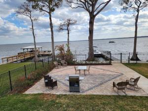 a patio with a table and chairs next to the water at Paradise on Lake Harris unit RV#5 in Leesburg