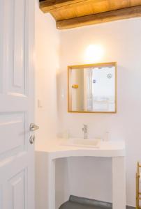 a bathroom with a sink and a mirror at Villa Phaedra by Whitelist Mykonos in Agios Ioannis Mykonos +21 photos