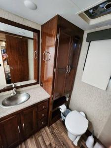 a bathroom with a sink and a toilet in an rv at Paradise on Lake Harris unit RV#5 in Leesburg