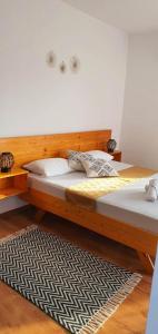 a bedroom with a wooden bed and a rug at Studio Harmony Techirghiol in Techirghiol
