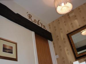 a room with a door and a chandelier at Yr Hen Felin - The Old Mill B&B in Morfa Nefyn