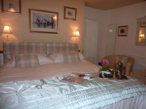 a bedroom with a bed with a book on it at Yr Hen Felin - The Old Mill B&B in Morfa Nefyn