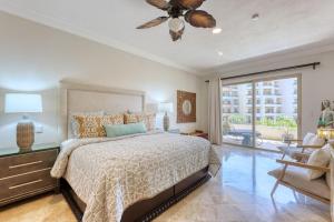 a bedroom with a bed and a ceiling fan at Villa La Estancia - Medano Beach Villas in Cabo San Lucas