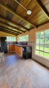 a large room with a kitchen with wooden ceilings at Coco Loco Lodge in El Valle