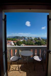 a balcony with a table and chairs and a view at Anatoli Residences in Alonnisos Old Town