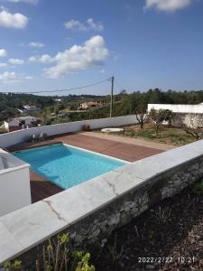 a swimming pool on the roof of a house at Casinha da Aldeia - country house with swimming pool in Santarém