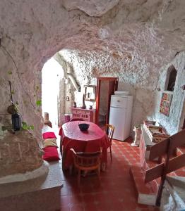 a dining room with a table in a stone house at La Serrana in Bedmar