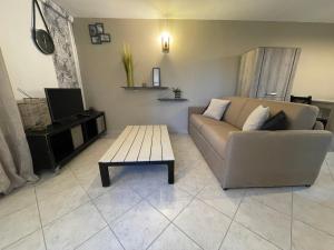 a living room with a couch and a coffee table at bas de Villa "Le Tiste" in Valensole