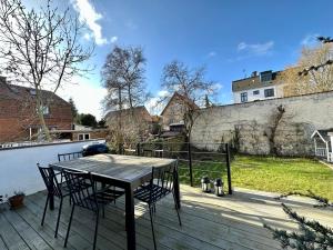 a wooden deck with a table and chairs on it at Copenhagen villa in Copenhagen