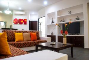 a living room with a couch and a coffee table at Almarea Vacation Condo in Playa del Carmen
