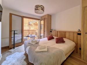 a bedroom with two beds and a large window at Chalet Saint-Martin-de-Belleville-Les Menuires, 5 pièces, 10 personnes - FR-1-344-1160 in Praranger