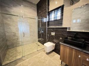 a bathroom with a shower and a sink and a toilet at Exquisite 5 Bedroom Villa in Kano in Kano