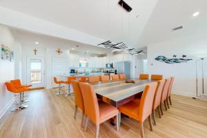 a kitchen and dining room with a table and chairs at SunKissed in Dauphin Island