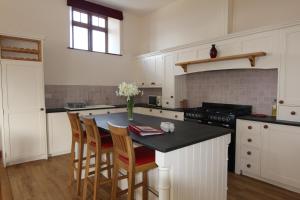 a kitchen with a kitchen island with a counter top at The Barn in Landkey