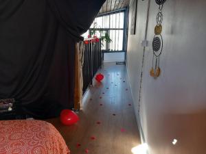 a room with red hearts on the floor and a room with a window at Palais des Rêves in Niort