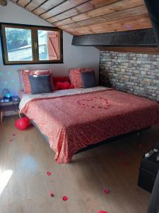 a bedroom with a large bed with a red comforter at Palais des Rêves in Niort