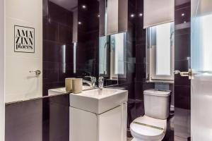 a bathroom with a white sink and a toilet at AP Embajadores IX in Madrid