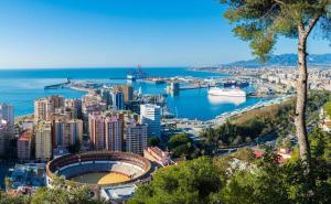 a view of a city with a harbor and the ocean at La Farola Centro de Málaga con Parking 445 Max in Málaga