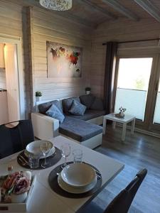 a living room with a table and a couch at Ferienhaus kleines Ostseeglück in Brodersby +13 photos