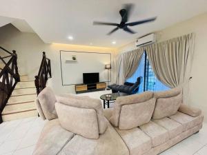 a living room with a couch and a ceiling fan at Ipoh 42 Symphony 12pax 4Bedroom 3bathroom 3carpark in Ipoh