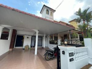 a motorcycle parked in front of a house at Ipoh 42 Symphony 12pax 4Bedroom 3bathroom 3carpark in Ipoh