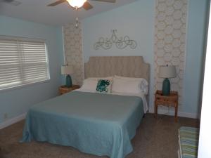 a bedroom with a large bed and two night stands at Bike & Beach Bungalow at Oyster Bay-Sunset Beach in Sunset Beach