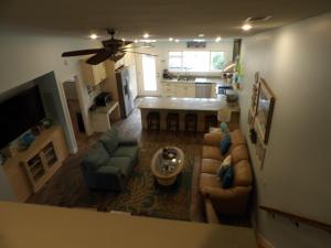a living room with a couch and chairs and a kitchen at Bike & Beach Bungalow at Oyster Bay-Sunset Beach in Sunset Beach