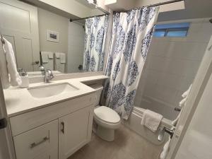 a bathroom with a sink and a toilet and a shower at Brand New 2 Brdm Suite - New House in North Vancouver