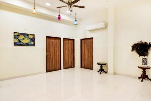 a room with wooden doors and a ceiling fan at Noble House - A Heritage Home in Jaipur