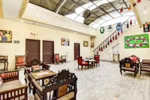 a large room with tables and chairs and a staircase at Noble House - A Heritage Home in Jaipur