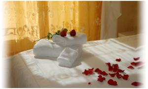 a couple of towels sitting on top of a bed at Gaia's Room B&B in Rome