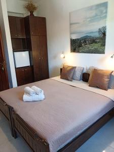 a bedroom with a large bed with towels on it at Karidia Apartments in Kissos