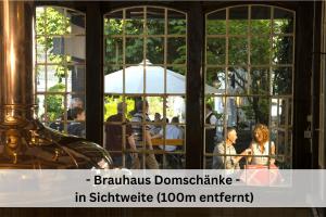 a group of people sitting at a table with an umbrella at Ferienhaus Pape - 300m2, 15 Betten - mit großem privatem Garten, Pool, Dart, Sauna-, Grill- und Spielbereich - Ideal für Familien in Eslohe +59 photos
