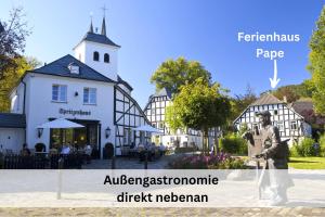 a building with a statue in front of it at Ferienhaus Pape - 300m2, 15 Betten - mit großem privatem Garten, Pool, Dart, Sauna-, Grill- und Spielbereich - Ideal für Familien in Eslohe