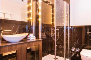 a bathroom with a sink and a glass shower at Loft Suite im modernen Style in Schärding in Schärding