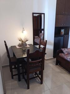 a dining room with a table and chairs and a mirror at Karidia Apartments in Kissós