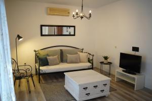 a living room with a bed and a tv at Villa Blatina in Gradac