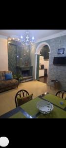 a living room with a table and a fireplace at Natali Apartment in Tbilisi City