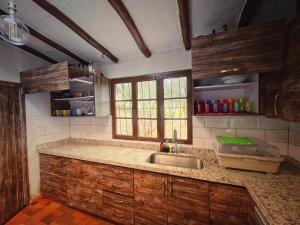 a kitchen with a sink and a counter top at The Naked House - Hotel Nudista in Nemocón