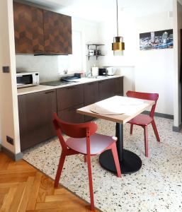 a kitchen with a table and two chairs and a table at Falcon Apartments Center 1 in Warsaw