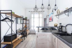 eine Küche mit weißen Wänden und Holzböden in der Unterkunft Nice Centre Flat - Modern, Quiet and Brand New in Nizza