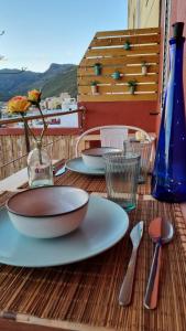 a wooden table with a plate and utensils on it at Casa Doris in San Sebastián de la Gomera