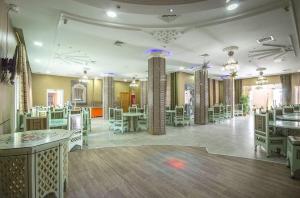 a large room with white tables and chairs at Saheb Ettabaa Tunis in Tunis
