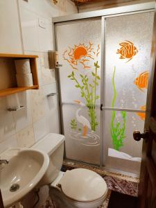 a bathroom with a shower with a toilet and a sink at Hostal Taita Cristobal in Isinliví