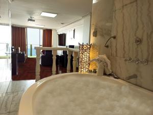 ein Bad mit einer Badewanne und ein Zimmer in der Unterkunft Inkari Apart Hotel in Lima