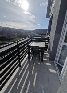 a table on the balcony of a building at Apartmani Stefan in Vrdnik