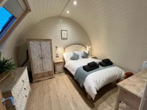 a bedroom with two beds in an attic at Riding Gate Lodge in Charlton Musgrove