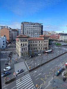 a city with a street with cars and buildings at Tía Ana in Gijón