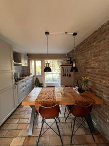 een keuken met een houten tafel en 2 stoelen bij Holiday home Elena in Slenaken